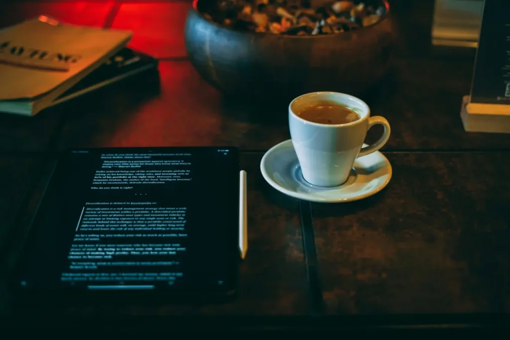 Digital tablet displaying an article next to a fresh cup of coffee